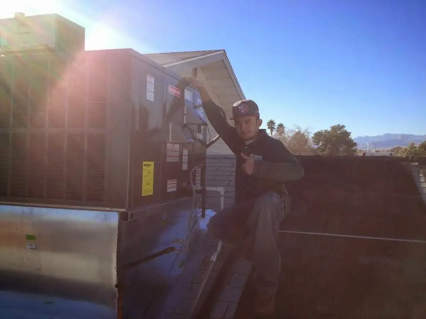 HVAC technician performing Boiler Repair on a rooftop unit in Brookings